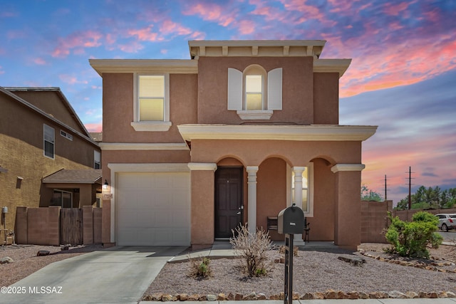 7952 E Revolution Loop, Tucson, AZ 85730 - view of front facade featuring a garage, driveway, stucco siding, and covered porch