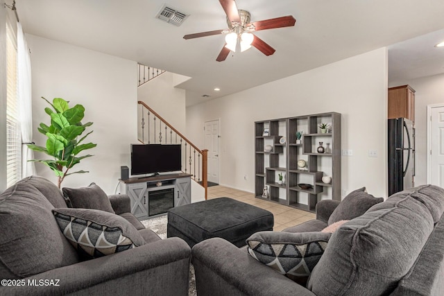 7952 E Revolution Loop, Tucson, AZ 85730 - living room with stairs, light tile patterned floors, ceiling fan, and recessed lighting