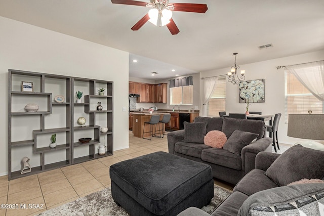 7952 E Revolution Loop, Tucson, AZ 85730 - living room with a chandelier, ceiling fan, light tile patterned floors, and recessed lighting