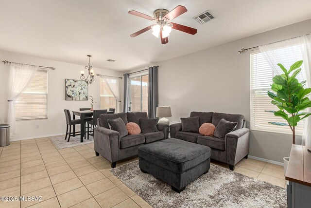 7952 E Revolution Loop, Tucson, AZ 85730 - living area featuring light tile patterned flooring, a chandelier, a ceiling fan, and healthy amount of natural light