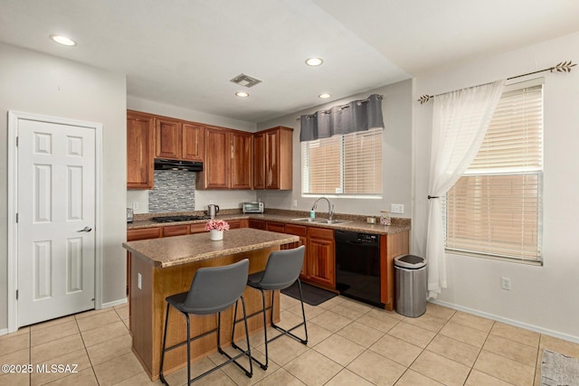 7952 E Revolution Loop, Tucson, AZ 85730 - kitchen with black appliances, a sink, under cabinet range hood, a kitchen island, and a breakfast bar