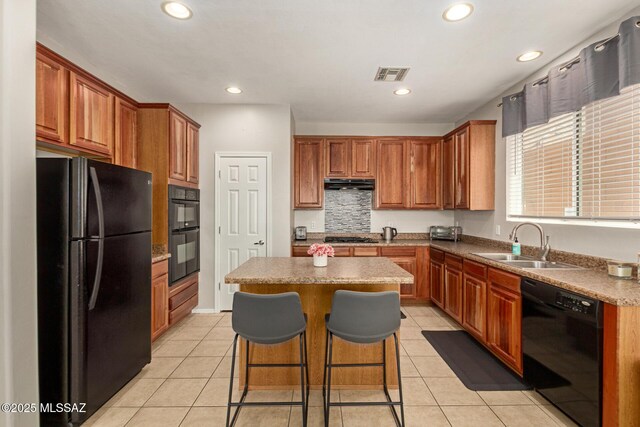 7952 E Revolution Loop, Tucson, AZ 85730 - kitchen featuring black appliances, a sink, under cabinet range hood, a center island, and light tile patterned floors