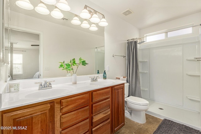 7952 E Revolution Loop, Tucson, AZ 85730 - bathroom featuring double vanity, curtained shower, toilet, and tile patterned floors