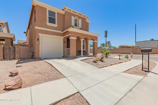 7952 E Revolution Loop, Tucson, AZ 85730 - view of front facade with covered porch, stucco siding, an attached garage, and concrete driveway