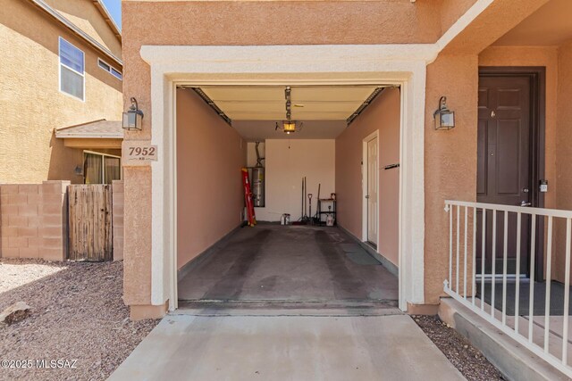 7952 E Revolution Loop, Tucson, AZ 85730 - property entrance with stucco siding, a garage, and water heater