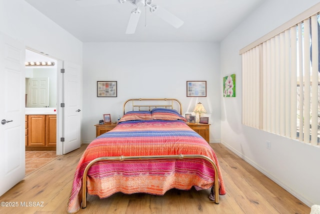 731 W Calle Montero, Sahuarita, AZ 85629 - bedroom featuring light wood-style floors, baseboards, ensuite bath, and a ceiling fan