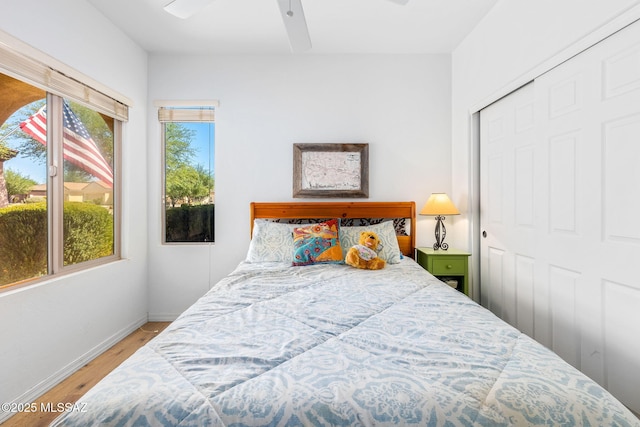 731 W Calle Montero, Sahuarita, AZ 85629 - bedroom featuring wood finished floors, baseboards, a closet, and a ceiling fan