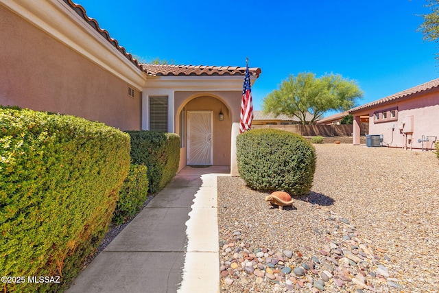 731 W Calle Montero, Sahuarita, AZ 85629 - doorway to property with stucco siding, a tiled roof, and central AC