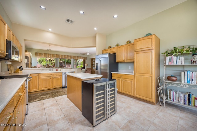 9345 N Cottage Garden Pl, Tucson, AZ 85743 - kitchen with appliances with stainless steel finishes, beverage cooler, a kitchen island, a sink, and recessed lighting