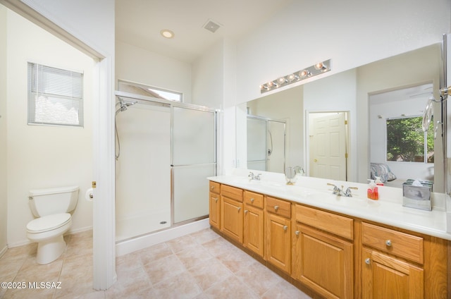 9345 N Cottage Garden Pl, Tucson, AZ 85743 - full bath featuring double vanity, a stall shower, toilet, and tile patterned floors