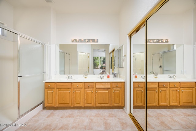 9345 N Cottage Garden Pl, Tucson, AZ 85743 - full bathroom featuring double vanity, a stall shower, and tile patterned flooring