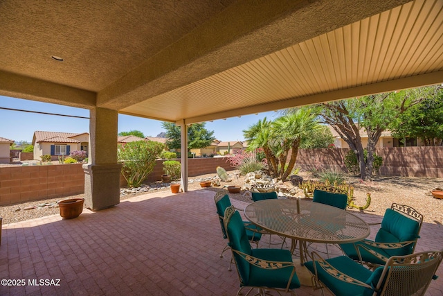 9345 N Cottage Garden Pl, Tucson, AZ 85743 - fenced backyard featuring a patio area, outdoor dining area, and a residential view