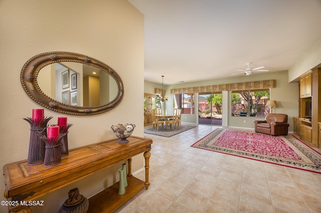 9345 N Cottage Garden Pl, Tucson, AZ 85743 - entrance foyer featuring ceiling fan, light tile patterned floors, a chandelier, and baseboards