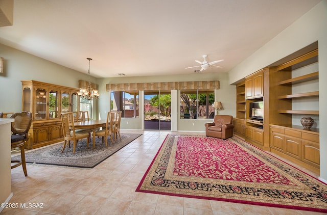 9345 N Cottage Garden Pl, Tucson, AZ 85743 - dining space with a chandelier, light tile patterned flooring, ceiling fan, and baseboards