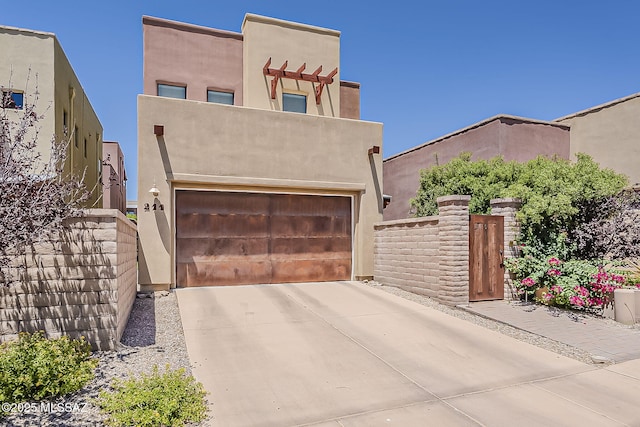 211 E Calderwood Rd, Tucson, AZ 85704 - pueblo-style home featuring concrete driveway, a garage, and stucco siding