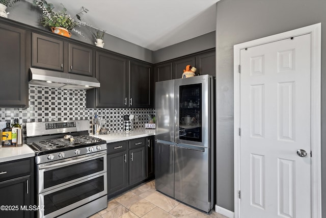 3630 W Center Mountain Way, Tucson, AZ 85746 - kitchen featuring appliances with stainless steel finishes, under cabinet range hood, tasteful backsplash, and light countertops