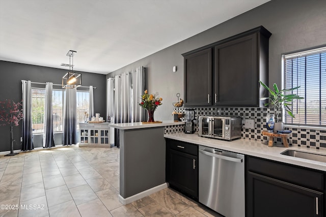 3630 W Center Mountain Way, Tucson, AZ 85746 - kitchen featuring dishwasher, light countertops, decorative backsplash, light marble finish floors, and a peninsula