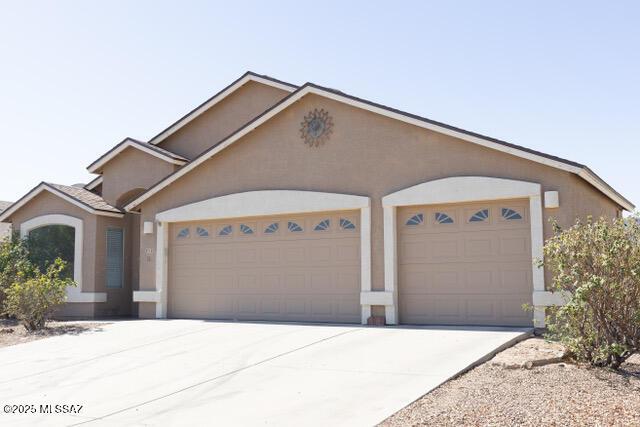 3715 W Fitzwater Ct, Tucson, AZ 85746 - view of front of house featuring an attached garage, concrete driveway, and stucco siding