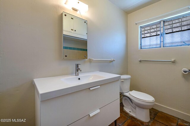 318 N Fremont Ave, Tucson, AZ 85719 - bathroom with toilet, vanity, and baseboards