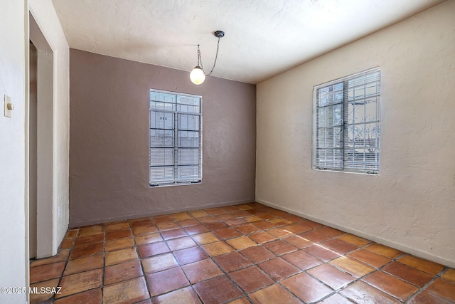 318 N Fremont Ave, Tucson, AZ 85719 - tiled spare room with a textured wall and baseboards