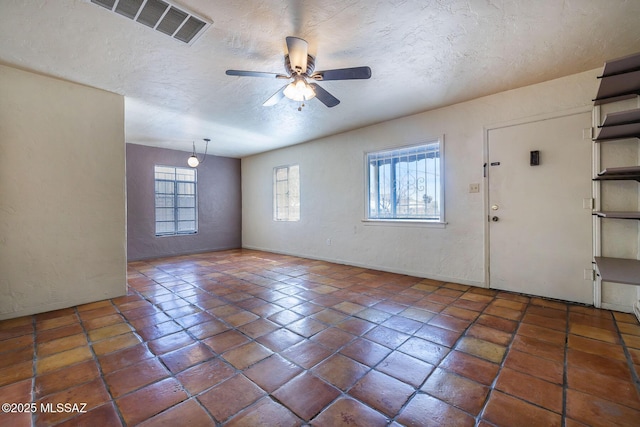 318 N Fremont Ave, Tucson, AZ 85719 - foyer entrance featuring a textured ceiling, a ceiling fan, tile patterned floors, a textured wall, and baseboards