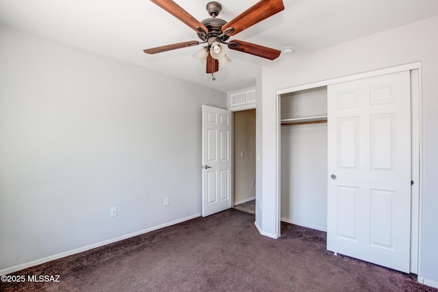 8068 S Nautilus Dr, Tucson, AZ 85756 - unfurnished bedroom with dark colored carpet, baseboards, a closet, and ceiling fan