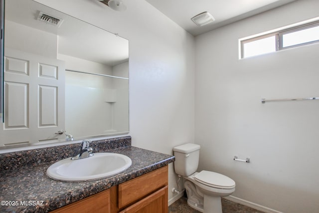 8068 S Nautilus Dr, Tucson, AZ 85756 - bathroom with vanity, toilet, a shower, and baseboards