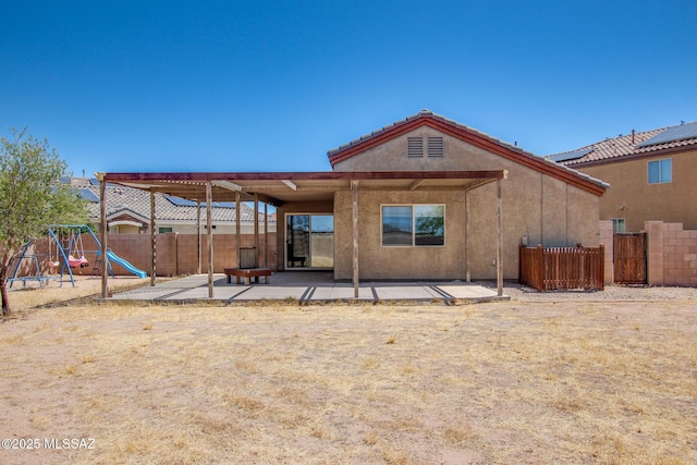 8068 S Nautilus Dr, Tucson, AZ 85756 - rear view of house featuring a patio, a fenced backyard, and a playground