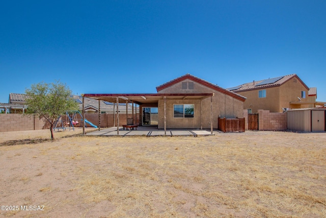 8068 S Nautilus Dr, Tucson, AZ 85756 - rear view of property with a fenced backyard, a patio area, and a playground