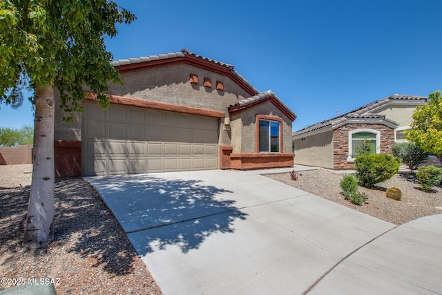8068 S Nautilus Dr, Tucson, AZ 85756 - mediterranean / spanish home with stucco siding, a tiled roof, and a garage
