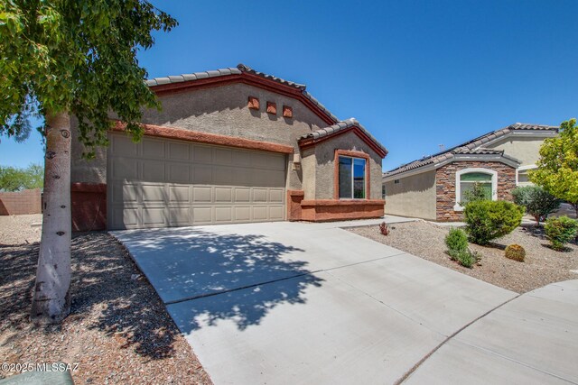 8068 S Nautilus Dr, Tucson, AZ 85756 - mediterranean / spanish home with stucco siding, a tiled roof, and an attached garage