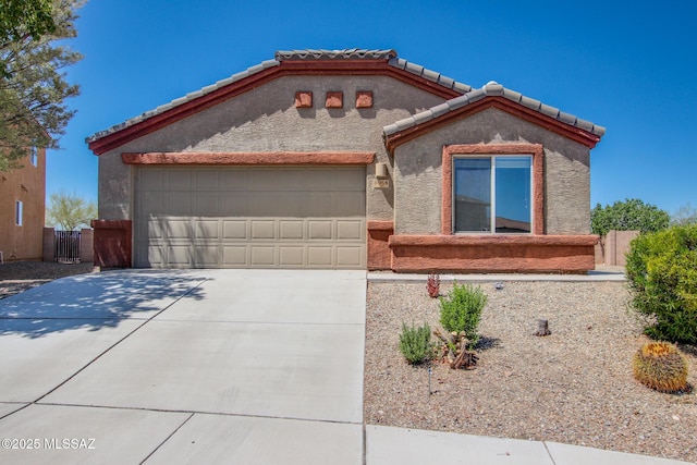 8068 S Nautilus Dr, Tucson, AZ 85756 - mediterranean / spanish-style house featuring concrete driveway, an attached garage, a tile roof, and stucco siding