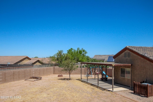 8068 S Nautilus Dr, Tucson, AZ 85756 - fenced backyard featuring a playground and a patio