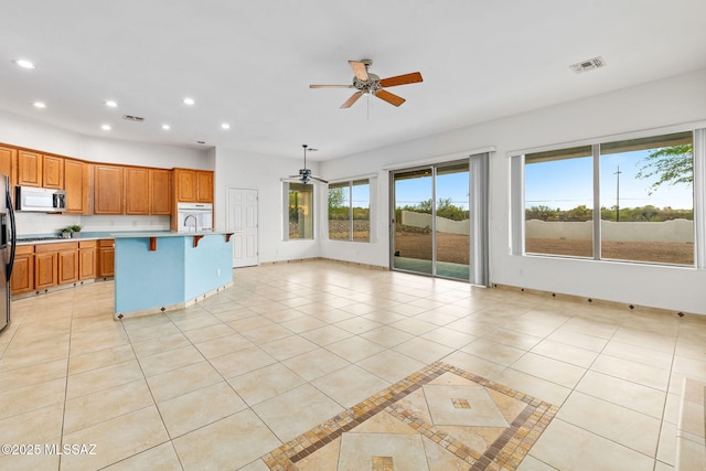 35 N Monument Estates Pl, Tucson, AZ 85748 - kitchen featuring ceiling fan, stainless steel microwave, recessed lighting, light countertops, and light tile patterned floors