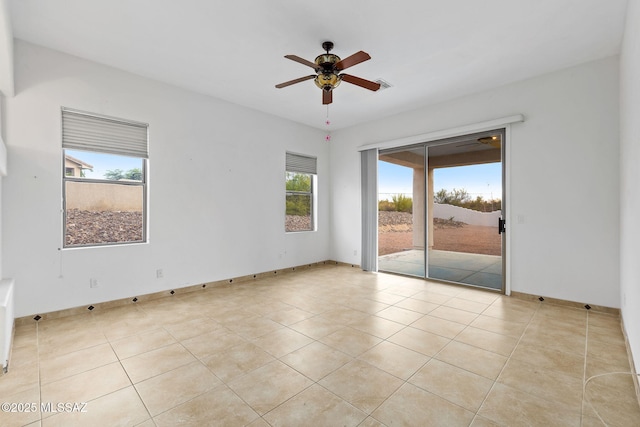 35 N Monument Estates Pl, Tucson, AZ 85748 - empty room featuring a ceiling fan, healthy amount of natural light, and light tile patterned floors