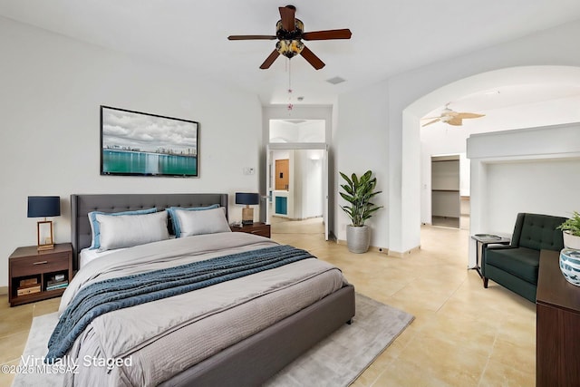 35 N Monument Estates Pl, Tucson, AZ 85748 - bedroom featuring light tile patterned flooring, arched walkways, and a ceiling fan
