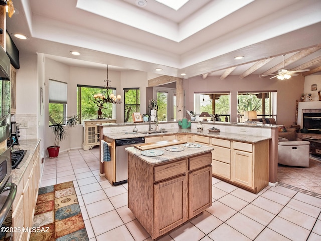 5475 E Placita De Royale, Tucson, AZ 85718 - kitchen with stainless steel dishwasher, a center island with sink, a sink, recessed lighting, and healthy amount of natural light