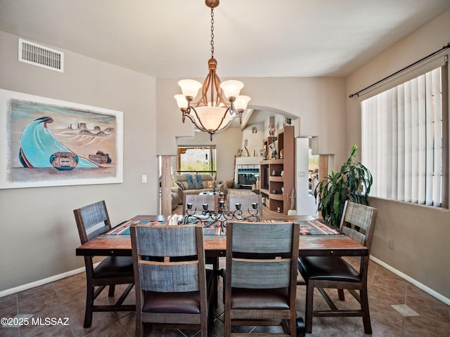 5475 E Placita De Royale, Tucson, AZ 85718 - dining space with a chandelier, tile patterned flooring, and baseboards