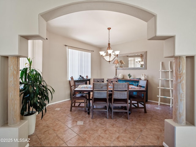 5475 E Placita De Royale, Tucson, AZ 85718 - dining area featuring a chandelier, plenty of natural light, arched walkways, and baseboards