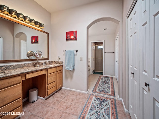 5475 E Placita De Royale, Tucson, AZ 85718 - bathroom with a closet, vanity, tile patterned floors, and baseboards