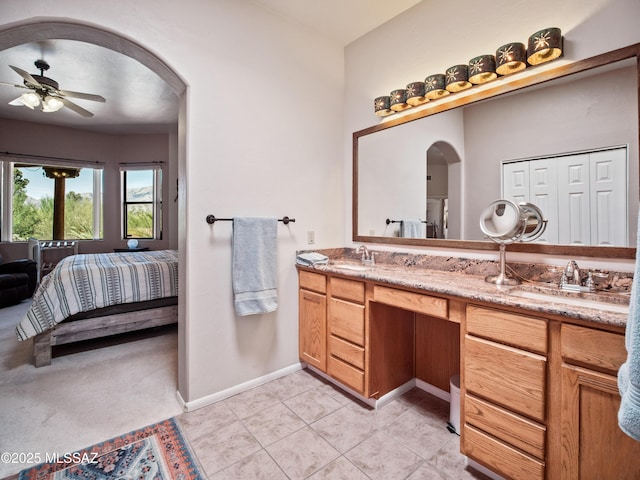 5475 E Placita De Royale, Tucson, AZ 85718 - full bath featuring ensuite bathroom, double vanity, ceiling fan, baseboards, and tile patterned flooring