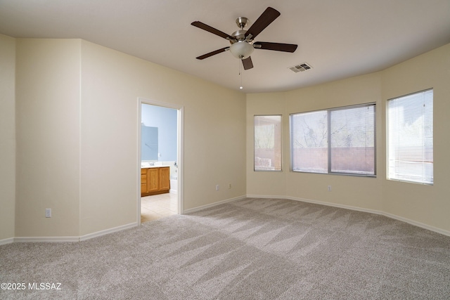 10393 Yew Pl, Tucson, AZ 85747 - empty room with light colored carpet, a ceiling fan, and baseboards