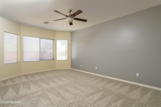 10393 Yew Pl, Tucson, AZ 85747 - empty room with light colored carpet, ceiling fan, and baseboards