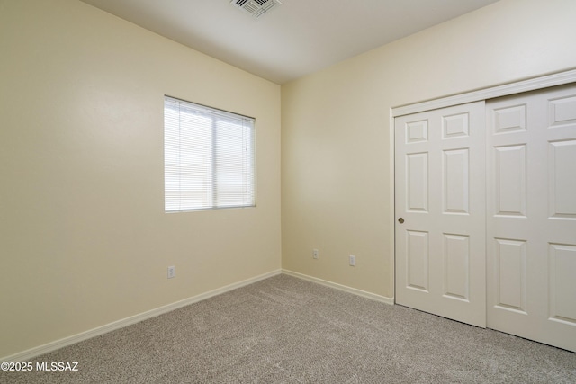 10393 Yew Pl, Tucson, AZ 85747 - unfurnished bedroom with carpet flooring, baseboards, and a closet