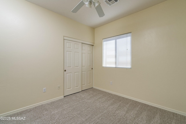 10393 Yew Pl, Tucson, AZ 85747 - unfurnished bedroom featuring carpet, baseboards, a closet, and ceiling fan