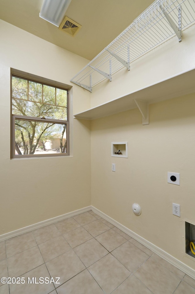 10393 Yew Pl, Tucson, AZ 85747 - laundry room featuring washer hookup, baseboards, and light tile patterned floors