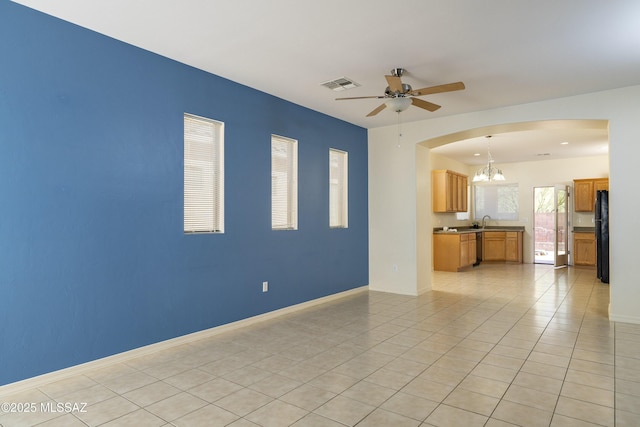 10393 Yew Pl, Tucson, AZ 85747 - unfurnished living room featuring a chandelier, arched walkways, ceiling fan, light tile patterned flooring, and baseboards
