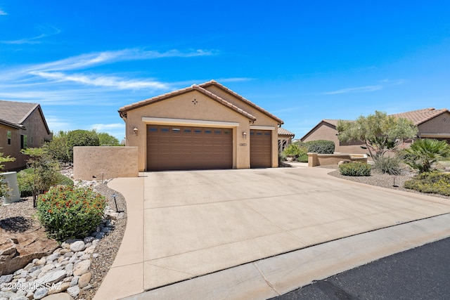 61050 E Amur Ln, Oracle, AZ 85623 - mediterranean / spanish-style house featuring driveway, an attached garage, stucco siding, and a tile roof