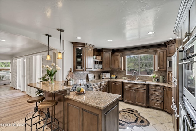 6945 N Mona Lisa Rd, Tucson, AZ 85741 - kitchen featuring a sink, a kitchen bar, healthy amount of natural light, tasteful backsplash, and recessed lighting