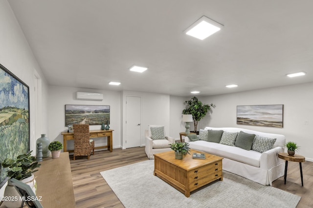 6945 N Mona Lisa Rd, Tucson, AZ 85741 - living room featuring a wall mounted air conditioner, light wood-style floors, and baseboards